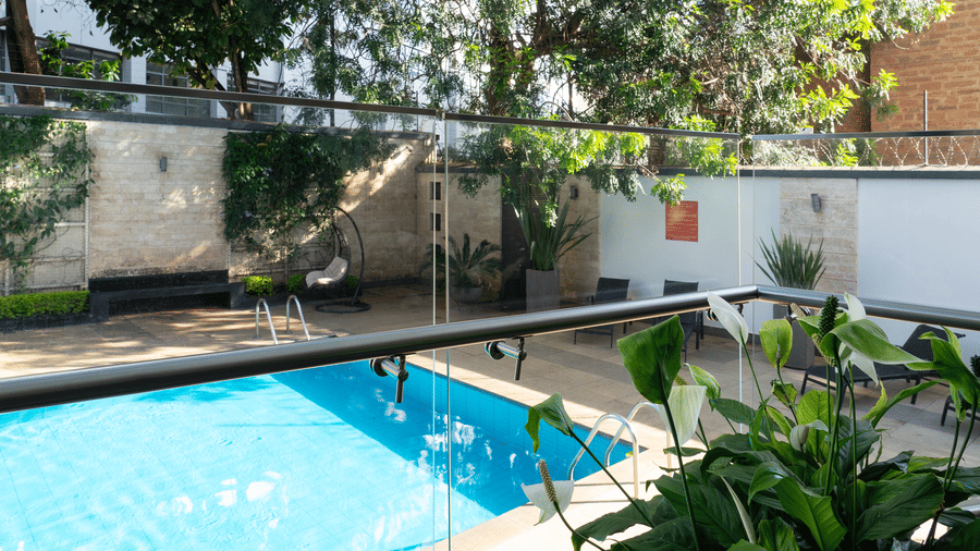 The serene swimming pool surrounded by greenery and walls at The Zehneria, Nairobi.