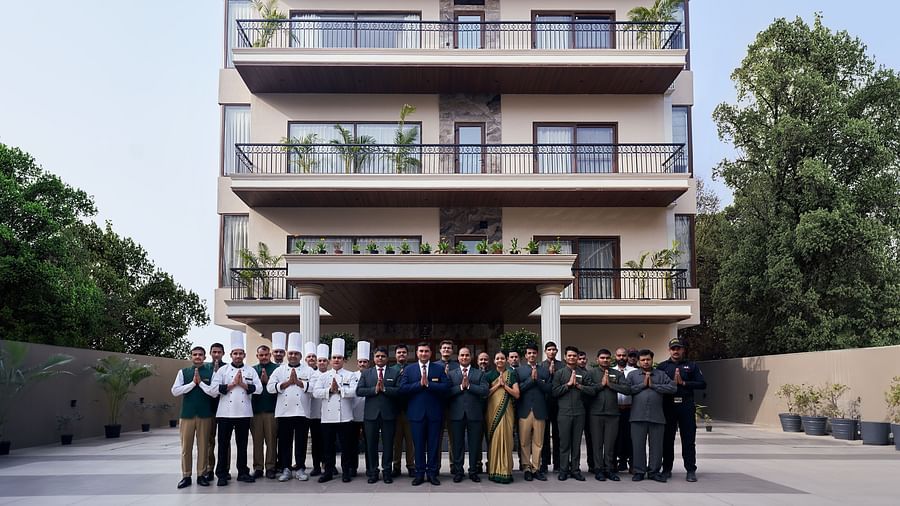 a group of people with folded hands welcoming guests to Triptam Hotel, Vrindavan