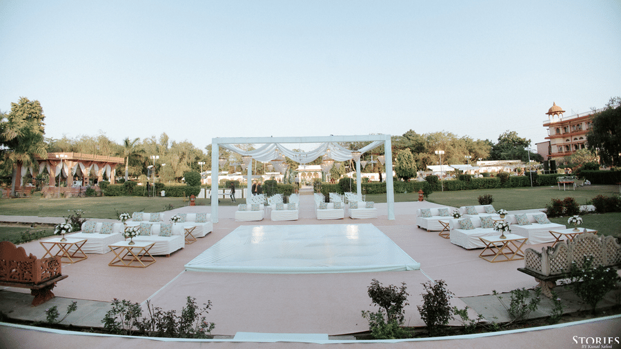 Outdoor lawn wedding setup with mandap and seating arrangement at Umaid Palace.