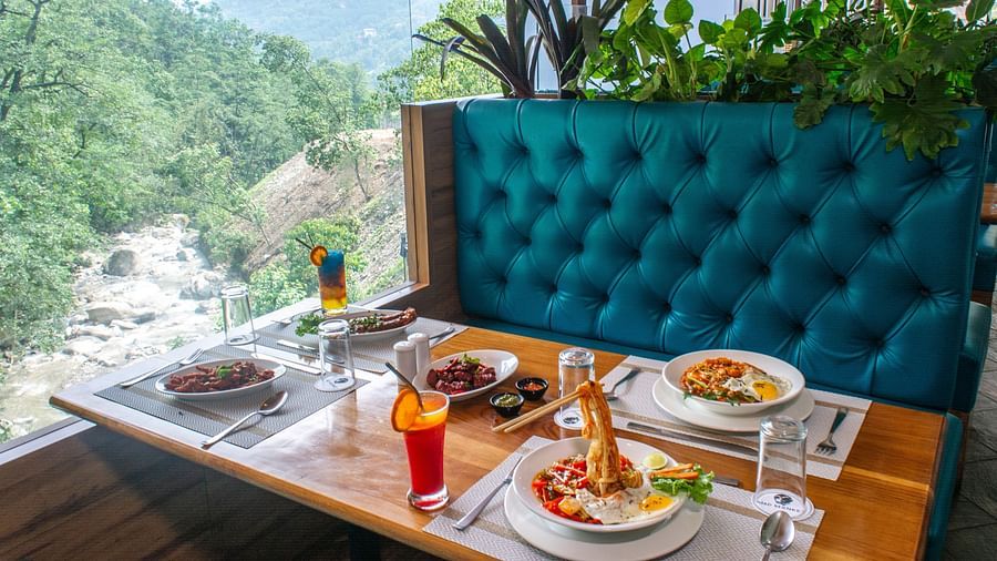Image of a dining sapce with view of the river and nature surrounding it at Avianna Ganagtok Resort and Spa
