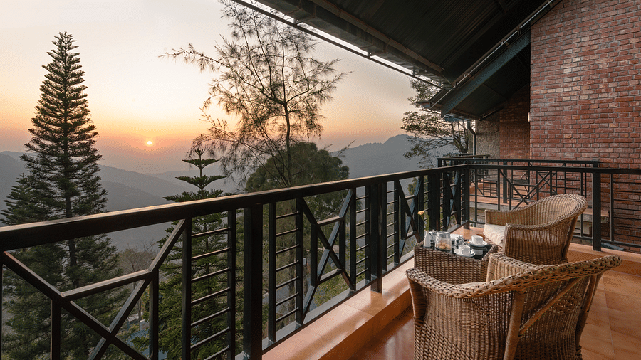 Superior Rooms seating area with a beautiful view of mountain during golden hour at Baikuth resort  kasauli.