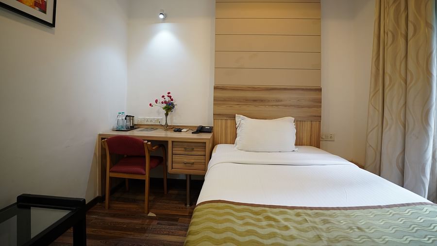 an image of a standard room with a portrait hanging on the wall at  City Centre Residency, Bangalore