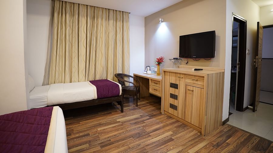 an image of executive bedroom with a television and working table at  City Centre Residency, Bangalore