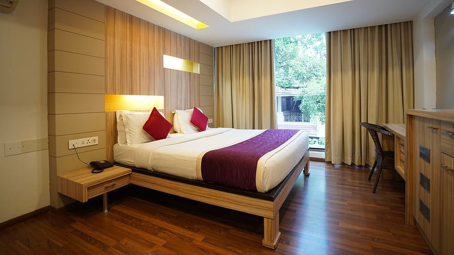 an image of a bed in a suite with a huge window at  City Centre Residency, Bangalore
