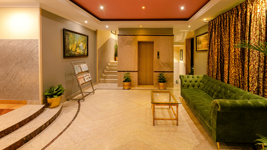 A welcoming reception area with soft lighting and elegant decor - Cross Roads Inn, Bengaluru