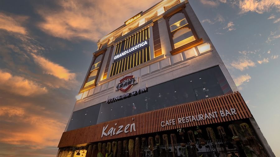 An angular shot of the facade of DLS Grand Luxotica, Dehradun under a vibrant twilight sky