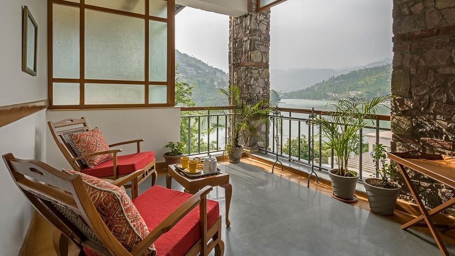 Sitting area with a beautiful view in the Superior Rooms at Fishermen's Lodge, Bhimtal, perfect for enjoying the serene surroundings.