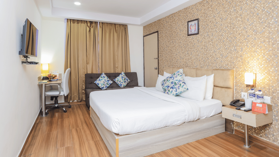 Another perspective of a hotel room featuring a double bed and simple elegant decor - Hyphen Grand, Haridwar
