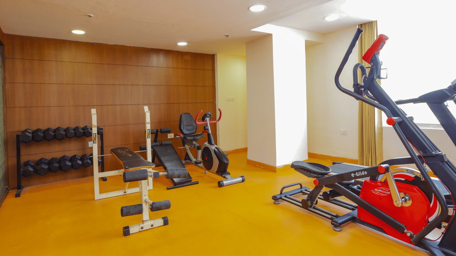 A well equipped gym featuring various exercise machines and weights - Hyphen Grand, Haridwar
