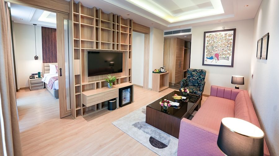 An image showcasing a living area of a suite with the bedroom seen in the back - NAMAMI BY ZENQ BANKHANDI