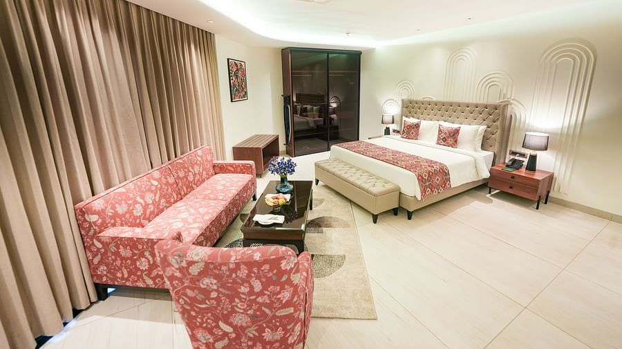 A queen size bed with a bed bench placed in front of an upholstered furniture - NAMAMI BY ZENQ BANKHANDI