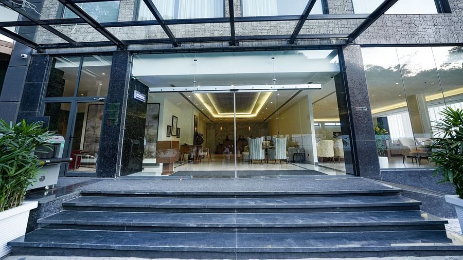 An image of the hotel entrance featuring large windows that open into the brightly lit hotel lobby - NAMAMI BY ZENQ BANKHANDI