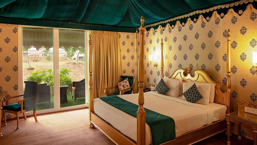 Image of Royal Luxury Tent a bed and an attached balcony on the side at Rajasthali Resort & Spa Jaipur.