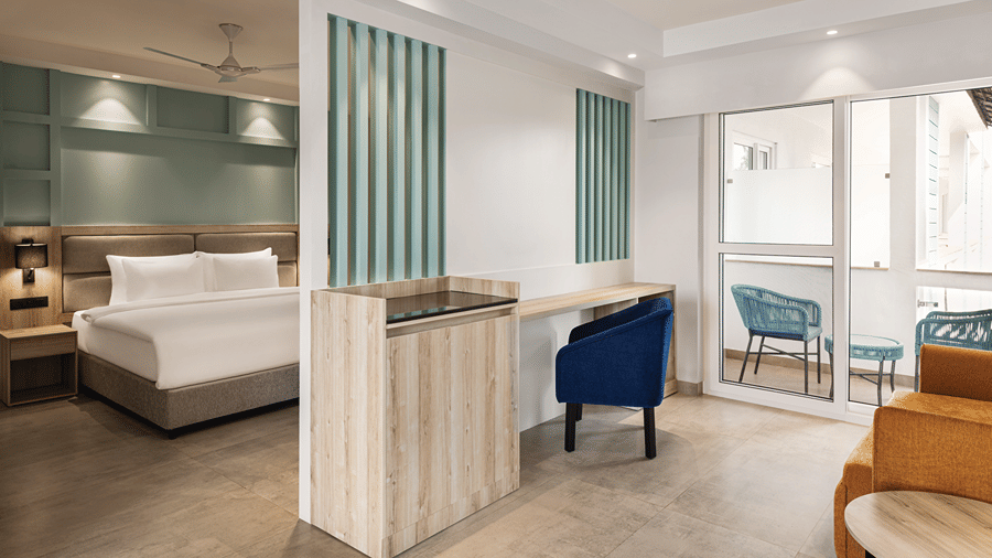 Spacious room with a king size bed, seating area and private balcony.