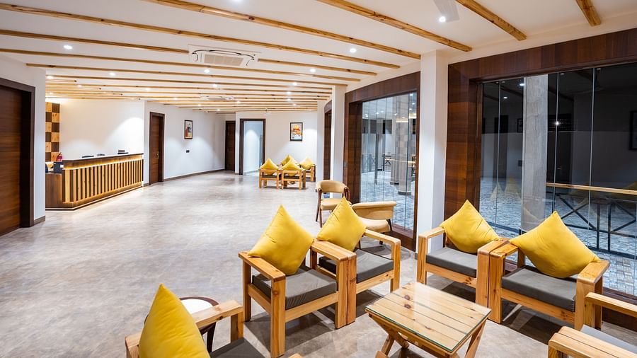A reception area with a reception desk and comfortable furniture to sit and relax on - Shervani Pebbles & Pines, Corbett
