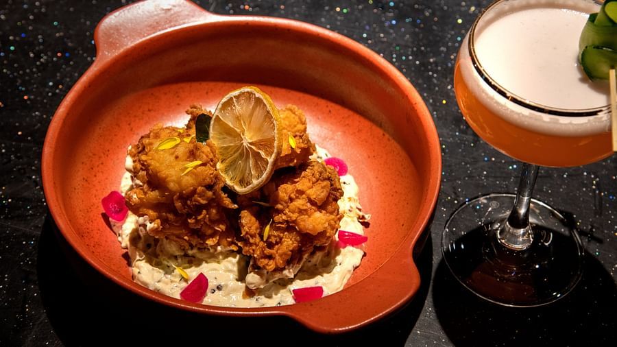 Image of CURRY LEAF FRIED CHICKEN and  a drink on the side at The Claridges New Delhi