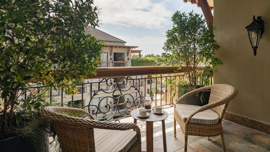 A beautiful balcony with an outdoor seating area overlooking the building opposite to it from the Premium Room at The Evren, Vagator.