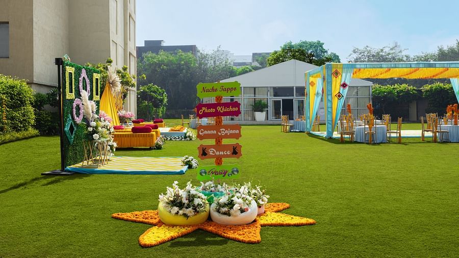 a view of a lawn with decorations and a canopy on the right side - The Hideaway Banquets & Lawns, Greater Noida