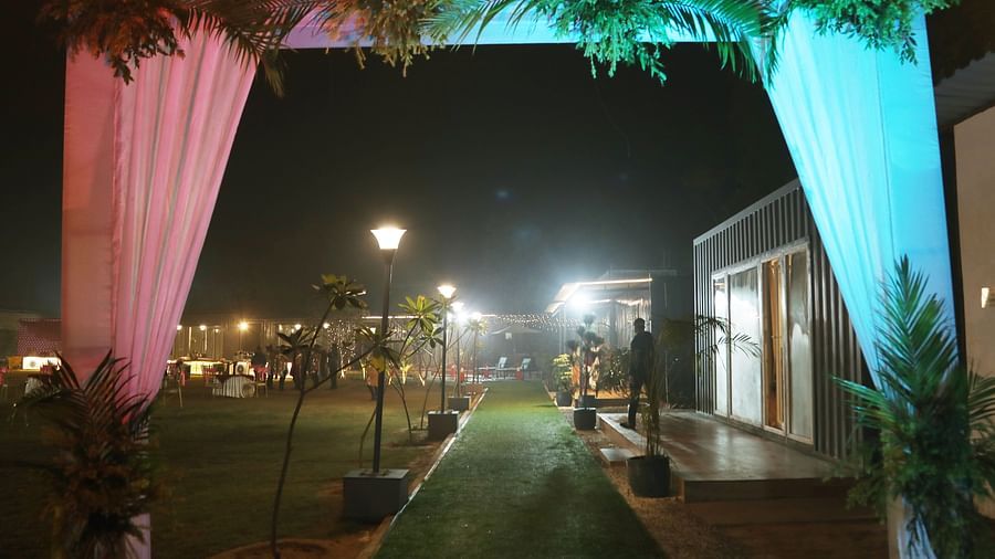 Walkway with draped fabric and lighting at night at Tisya Farms, Gurgaon.