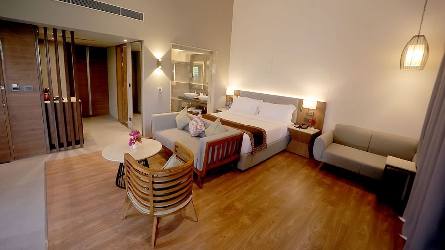 Room with wooden flooring, soft ambient lighting, and a welcoming seating corner at Wyndham Garden.
