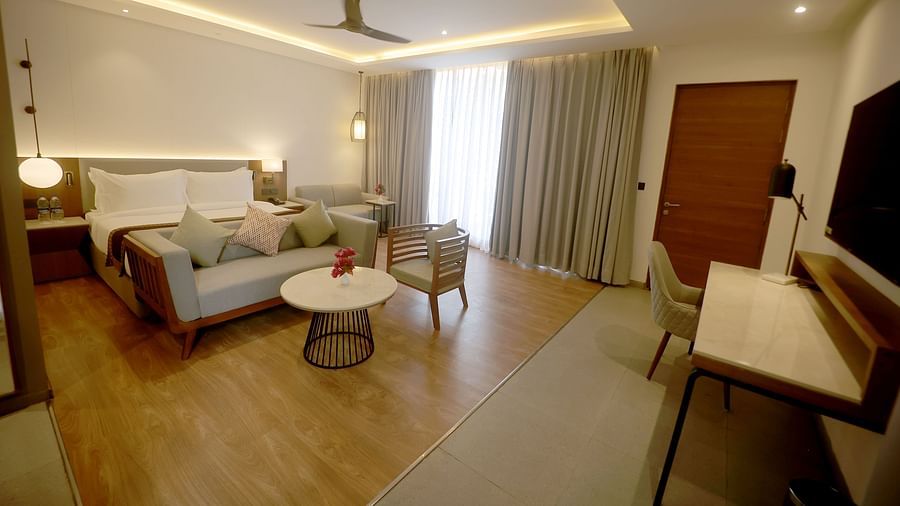 Elegant room with modern lighting, twin sofas, a coffee table, and work desk at Wyndham Garden.