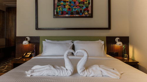 casa tropicana room with a king size bed and towel art at Symphony Samudra Beachside Jungle Resort And Spa, Port Blair
