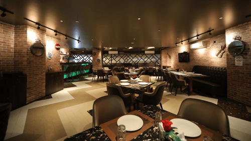 Seating arrangements inside the bar & restaurant with modern interiors - VITS Bharat Nanded