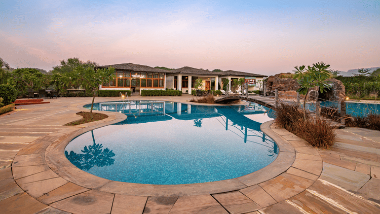 swimming pool and lounge area at The Baagh 