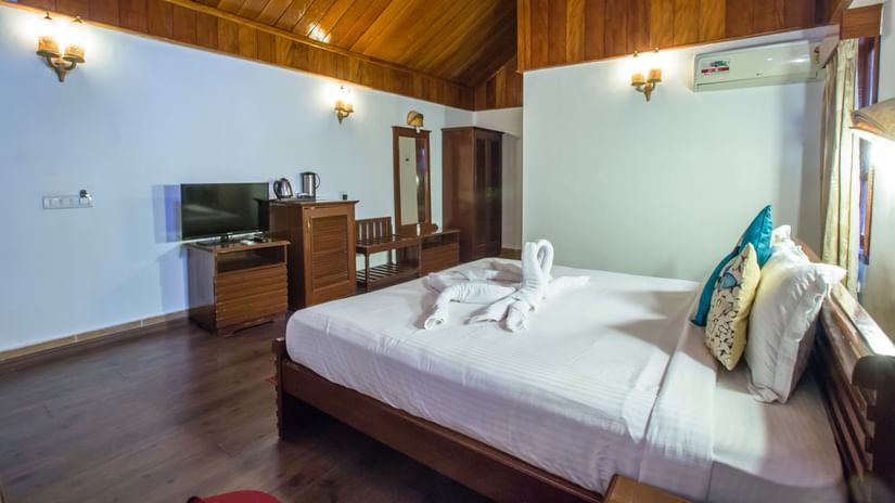 A bedroom with a pitched roof
