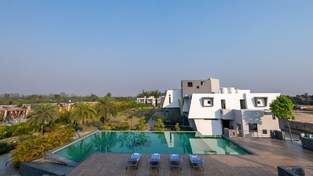 Swimming pool with sun loungers and scenic views - DLS Forest Vines Resort & Spa, Ramnagar (Jim Corbett)