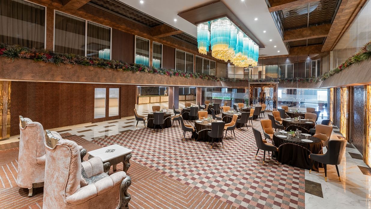 Chic lounge area with patterned flooring, plush seating and ambient lighting at Clarks Inn Suites, Hyderabad
