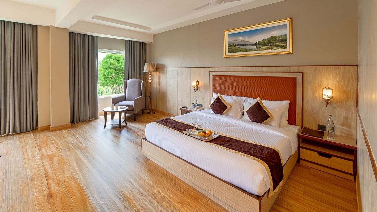 Elegant twin bedroom with large windows at The Lalita Grand hotel.