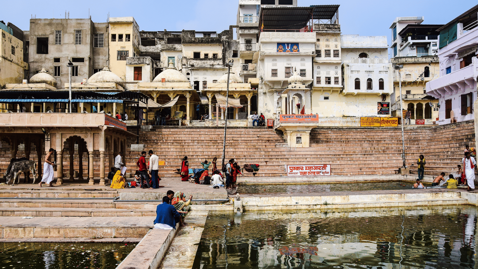Facade of the buildings with a water body right below it.