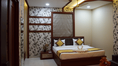 A modern luxury hotel bedroom in Varanasi, showcasing elegant decor, ambient lighting, and comfortable furnishings available through exclusive Varanasi hotel deals - Hotel Uday Palace.