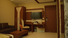 A spacious hotel suite with modern furnishings and elegant interior design offering luxury accommodations through Varanasi hotel deals - Hotel Uday Palace.