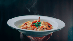 man holding the plate with delicious food elegently
