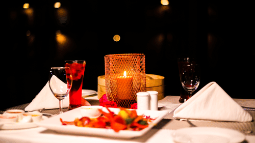 A close-up shot of a candlelight dinner set up underneath the stars