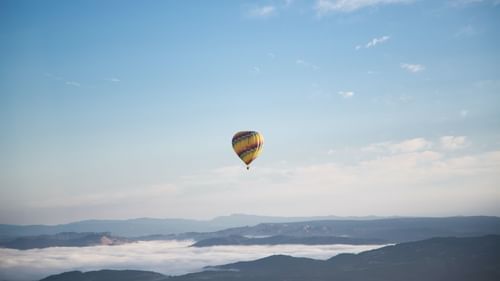 image of a hot air balloon floating in the air with vast breathtaking views