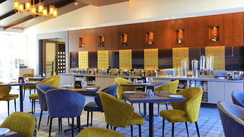 Yellow and Blue chairs with bright celing lights