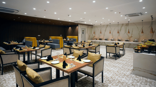 tables and buffet stations inside Golpo at Sarovar Portico, Kolkata Rajarhat