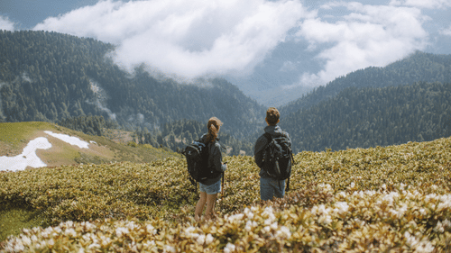 A couple having a great time looking over mountains