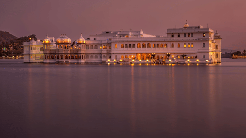 Image of a palace in the middle of a lake at night
