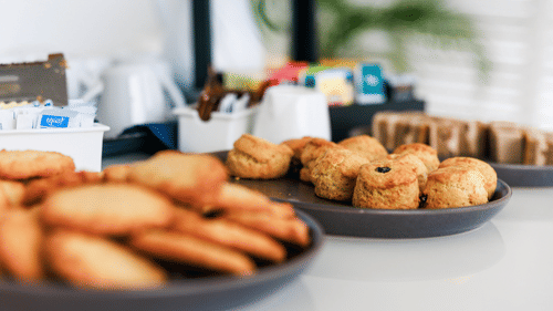Variety of food served at the table with the focus on one of the biscuit item at The Soco House.