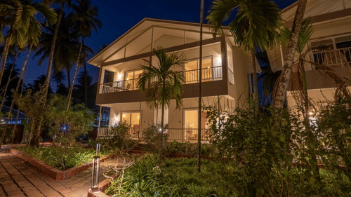 Facade image of VITS Select Casuarina, a Diveagar resort near beach, with greenery around it during the night