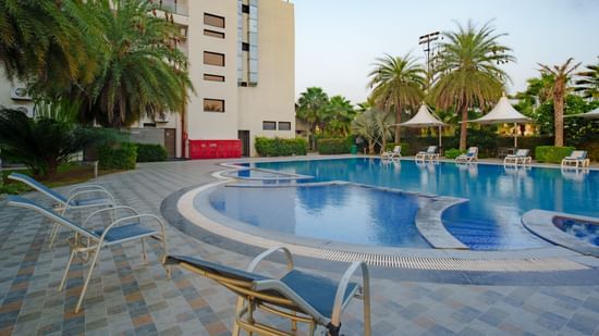Exterior view of the hotel building overlooking the swimming pool at Arawali Ananta Elite, Jaipur.