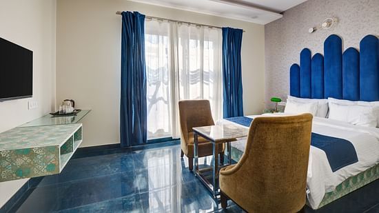 Blue themed Superior Deluxe Room with chairs and LED TV - The White Moon