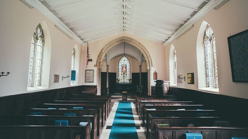 seating arrangements inside a chapel with the diaz in the background