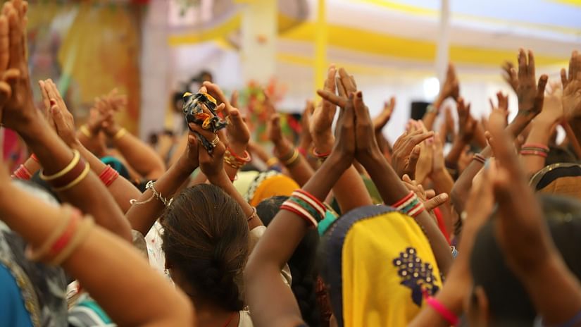 Group of people folding their hands and offering prayers to the lord