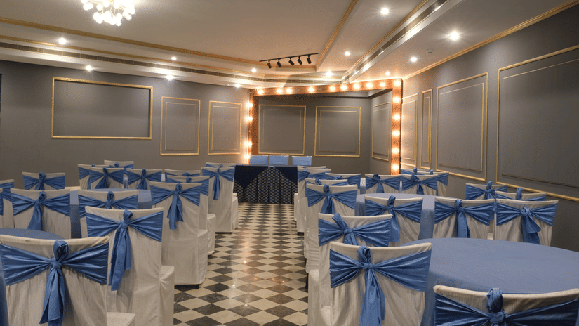 The beautifully appointed Party Hall with decorative lighting, elegant chair decor, and a cosy setting ideal for engagement ceremonies, cocktail evenings, and private celebrations | Clarks Amer, Jaipur