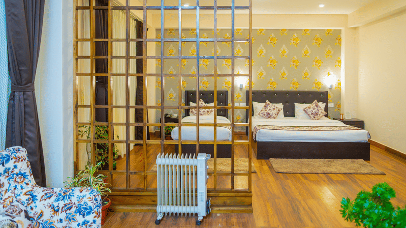 Modern bedroom at Voyage Dream Villa Retreat with decorative grid partition, floral wallpaper, wooden floors, and contemporary furnishings